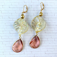 Lenora Dame earrings Gold tone drop earrings with iridescent twisted leaves and tear drop faceted peach crystals.