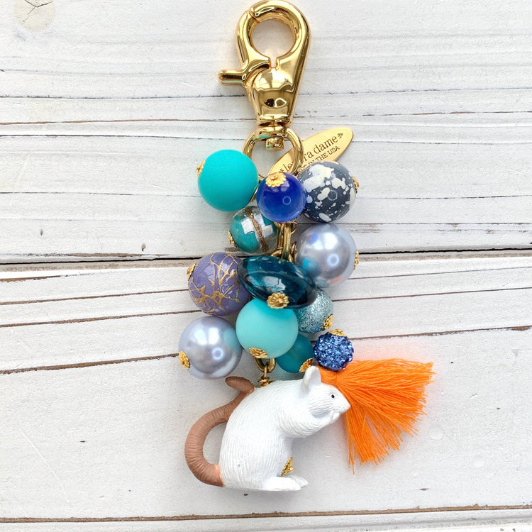 Blue beaded bag charm with white mouse charm at the bottom and gold trigger clasp at top. Cute bag charms for handbags.