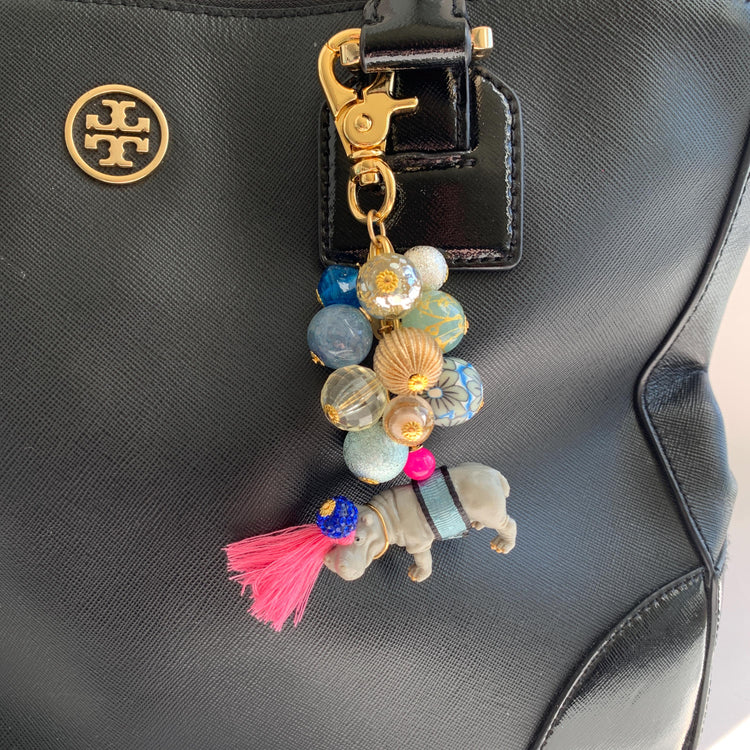 Hippo keychain with miniature hippo charm and a mix of blue and gold beads on a gold chain with gold trigger clap. Hippo bag charm for purse.