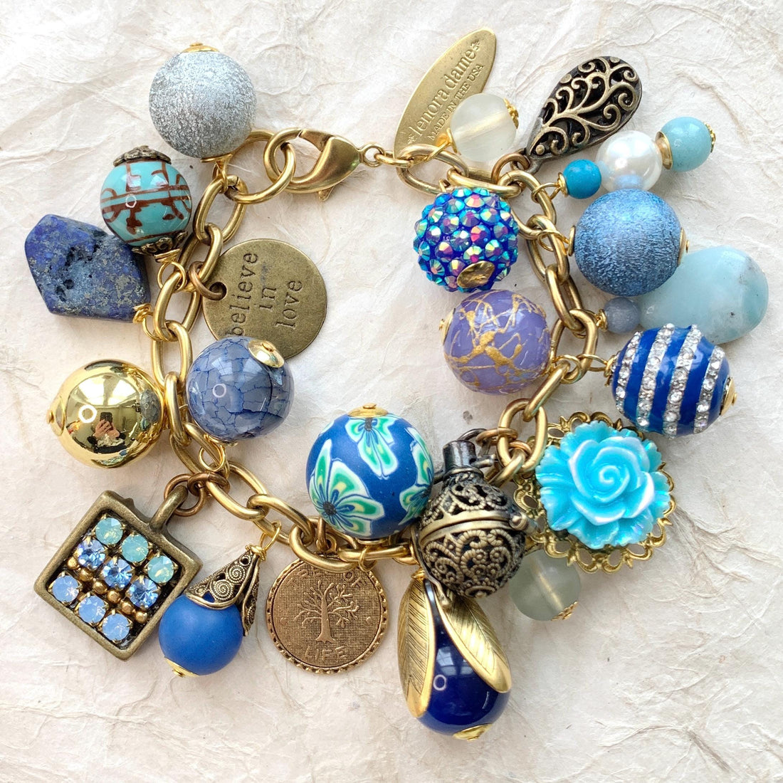 Chunky charm bracelet for women with assorted beads, metal charms, flowers, semiprecious stones, and rhinestone charms. Handmade jewelry for women. Lenora Dame bracelets.