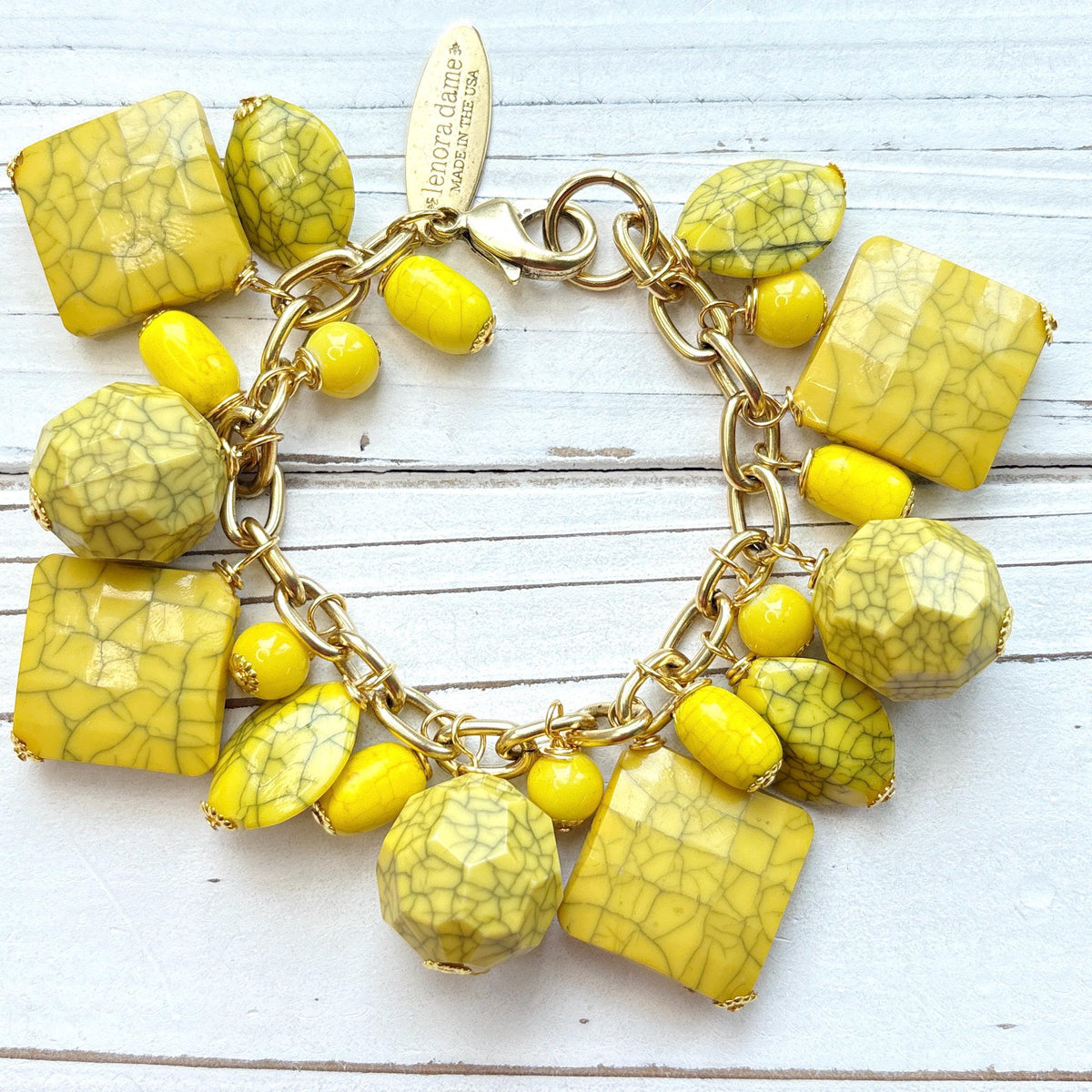 Yellow beaded bracelet for women with square, oval, and round yellow beads with a black crack design wire wrapped on a gold chain with lobster clasp and Lenora Dame Made in USA hang tag. Lenora Dame bracelet.